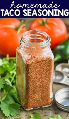 homemade taco seasoning in a mason jar with tomatoes and cilantro on the side