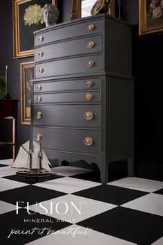 a black and white checkered floor with an antique dresser