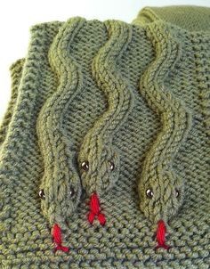 a knitted green sweater with red buttons on it