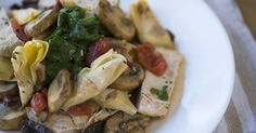 a white plate topped with pasta and mushrooms