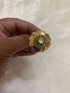 This beautiful peach-colored Kundan ring is perfect for adding a touch of elegance to any outfit. The ring features a stunning peach-colored main stone that is sure to catch the eye. Its intricate design and attention to detail make it a true work of art. Crafted with care and with an eye for detail, this ring is a must-have for any jewelry collection. Its timeless beauty is sure to endure, making it an excellent investment for any fashion-savvy individual. The ring is perfect for any occasion, Kundan Ring, Indian Ring, Ladies Sangeet, Ring Indian, Indian Rings, Bollywood Jewelry, Golden Ring, Big Rings, Kundan Jewellery