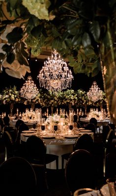 an elegant wedding reception with chandeliers and tables set up for the guests to sit down