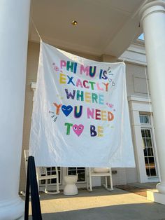 a banner that says phu is exactly where you need to be hanging on the side of a building