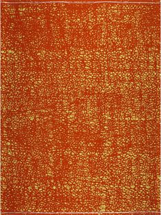 an orange rug with gold dots on it