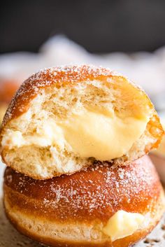 two doughnuts stacked on top of each other with butter and powdered sugar