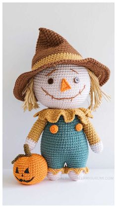 a crocheted scarecrow with a pumpkin