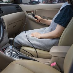 a woman sitting in the driver's seat of a car