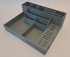 a gray tray with compartments on top of it