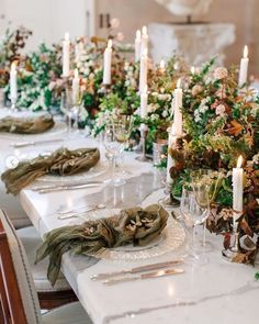 a long table is set with candles and greenery for an elegant dinner party or wedding reception