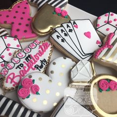 decorated cookies are arranged in the shape of hearts, spades, and playing cards