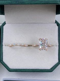 an engagement ring in a gift box with the diamond setting on it's side