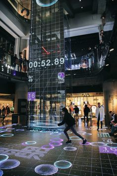 a person is dancing on the floor in front of a large clock