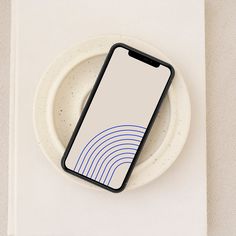 a cell phone sitting on top of a white plate