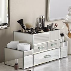 an organized bathroom vanity with mirrored drawers