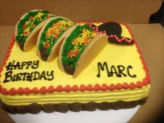 a birthday cake decorated with mardi gras decorations on top of a white plate