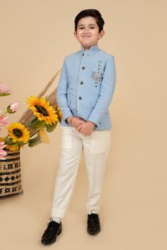 Sky blue full sleeves bandhgala in suiting base with placement bloom resham thread embroidery and faux pocket flaps detail. Paired with an off white pant. - Aza Fashions Off White Pants, Boys Closet, White Pant, Boys Kurta, Online Closet, Blue Embroidery, Thread Embroidery, Kids Pants, Band Collar