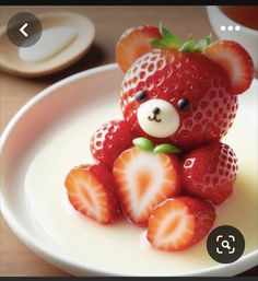 a teddy bear made out of strawberries on a plate