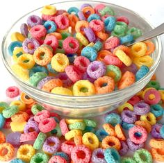 a bowl filled with colorful cereal sitting on top of a table