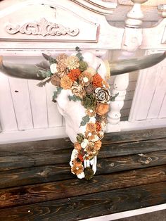 a bouquet of flowers is placed on the back of a bench in front of a door