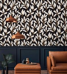 a living room with two leather chairs and a coffee table in front of the wall