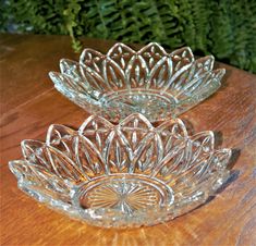 three glass dishes sitting on top of a wooden table