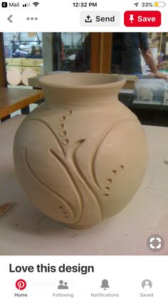 a white vase sitting on top of a table