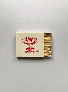 a matchbox with matches in it on a white surface, that says devils stove vermont