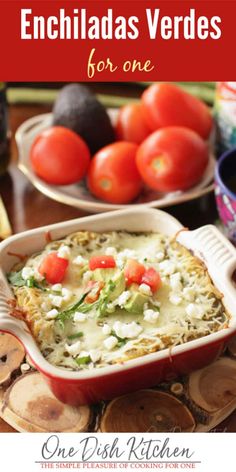 an enchiladas verdes casserole with cheese and tomatoes on the side