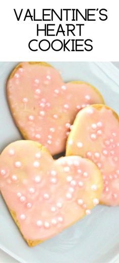 two heart shaped cookies on a plate with the words valentine's heart cookies over it