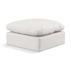 a white pillow sitting on top of a bed