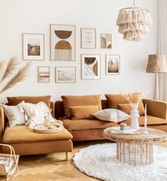 a living room filled with furniture and pictures on the wall