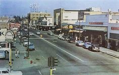 an old photo of a city street in the 1950's or early 1960s's