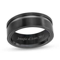 a black ceramic wedding ring with an engraved inscription