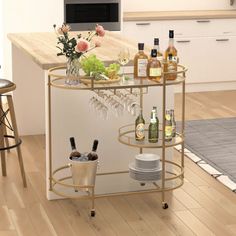 a kitchen island with wine glasses and bottles on it