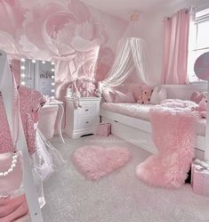 a bedroom decorated in pink and white with flowers on the wall, bedding and rugs