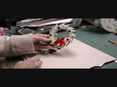 someone is making a wreath out of paper