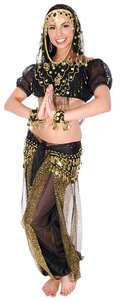 a woman in belly dance clothes posing for the camera with her hands clasped up to her chest