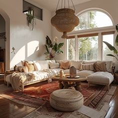 a living room filled with lots of furniture and large windows above the couches in front of them