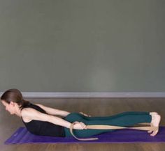 a woman is doing yoga on a mat