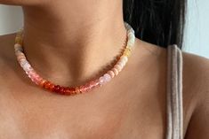 Sunset Necklace. My sunset-inspired gemstone bead necklace exhibits vibrant hues of red, orange, pink, and yellow creating a captivating piece that embodies the beauty of twilight.                       Know your jewelry. 🟢Gemstones: Red Aventurine, Carnelian, Rose Quartz, Cherry Quartz, Yellow Jade, Grey Agate 🟢 Bead size - 8x5.5mm Smooth Rondelle *Knotted Silk Thread 🟢 Mechanism - Lobster Clasp with 2" extender 🟢 Necklace length. - 16" (Bead section 14.5") (on model) - 18" (Bead section 17 Luxury Pink Rondelle Necklaces, Luxury Pink Rondelle Necklace, Handmade Orange Crystal Necklaces With Round Beads, Adjustable Orange Gemstone Beaded Necklace, Gem Candy, Candy Necklace, Candy Necklaces, Bead Choker, Pink Gem