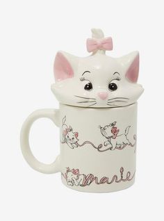 a white ceramic mug with a cat on it's lid and the words mane