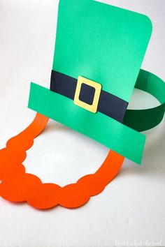 a green hat and orange beard on a white background