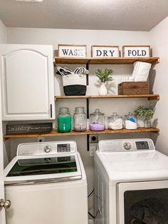 a washer and dryer in a small room with shelves above the washer