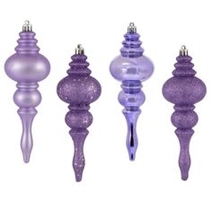 purple glass candlesticks are lined up against a white background with glitter on them