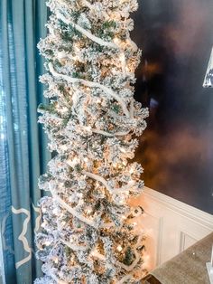 a white christmas tree with snow on it