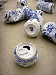 several blue and white vases sitting on the ground