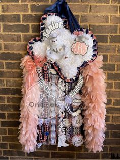 a pink and white jacket hanging on a brick wall