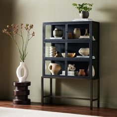 a shelf with vases and other items on it