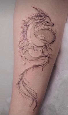 a black and white photo of a dragon tattoo on the right arm, it looks like something out of a fairy tale