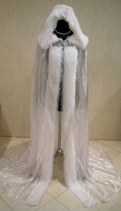 a white cape with fur and beads on it